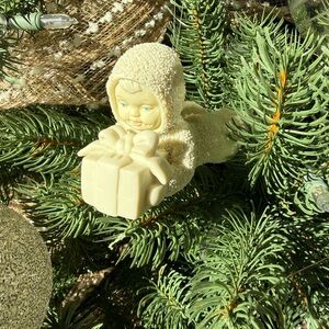 Department 56 Snowbabies overnight delivery baby holding a present